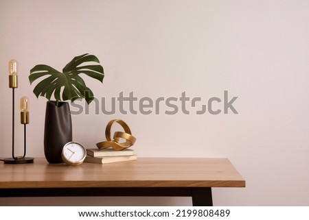 Minimalist composition of elegant home office space with design chair, black vase with leaf, sculpture, book and personal accessories. Copy space. Minimalist home decor. Template.	
