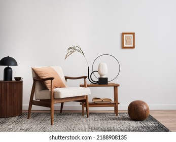 Minimalist composition of elegant living room space with white boucle armchair, photos mock up frames, carpet, coffee table, lamp, decoration and personal accessories. Copy space. Template.  - Shutterstock ID 2188908135