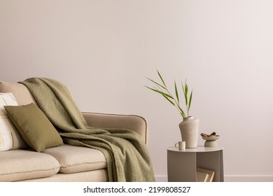 Minimalist composition of elegant and outstanding space with beige sofa, coffee table, vase, green plaid and pillow. Beige wall. Home decor. Template.  - Shutterstock ID 2199808527
