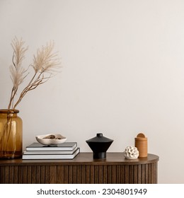 Minimalist composition of living room interior with copy space, wooden commode, vase with dried flowers, candle, black books and personal accessories. Home decor. Template.  - Shutterstock ID 2304801949