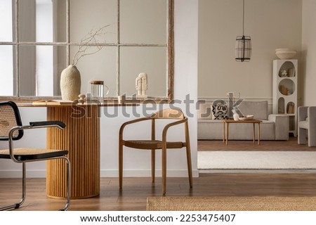 Minimalist composition of open space interior with wooden chair, stylish vase with dried flowers, modular sofa, pitcher, cup, braided rug, lamp and personal accessories. Home decor. Template.