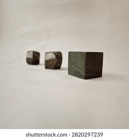 Minimalist Composition of Stone Cubes arranged in Perspective on Neutral Background