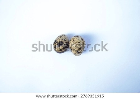 Minimalist composition of two quail eggs on a clean white background with ample copy space, perfect for healthy food concepts, organic lifestyle, and culinary design.