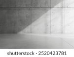 Minimalist concrete wall with sunlight casting a diagonal shadow across the floor.