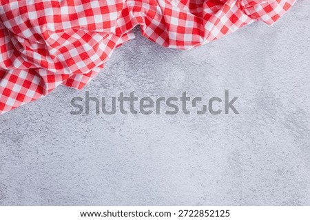 Minimalist Dining Background with Red Tablecloth Accent. A minimalist and clean dining background using the familiar red check pattern. Features a large blank area, copy space for design use.