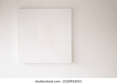 A Minimalist Empty Canvas Displayed on a White Wall, Perfect for Artistic Backgrounds - Powered by Shutterstock