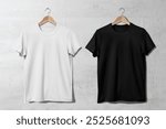 A minimalist fashion display featuring basic t-shirt fashion casual wear. Basic t-shirt for casual wear hanging on the wall. Simple apparel t-shirt black and white fashion.