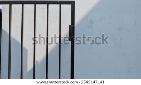 a minimalist house fence with the shadow