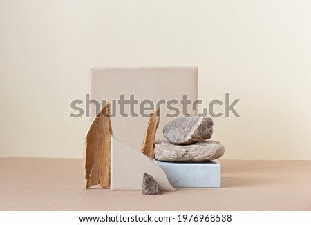 Minimalist monochrome still life composition with  natural nature materials: stone, marble, earthy clay and plant dry branch in beige color, copy space, abstract modern art design concept