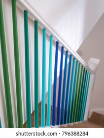 Minimalist Oak Staircase With Blue And Green Ombre Painted Stair Spindles. 