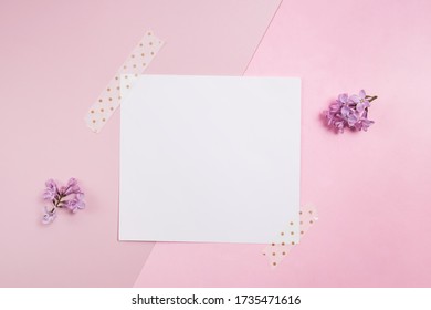 Minimalist paper card mock-up. Empty card on pink background with small lilac flowers - Shutterstock ID 1735471616