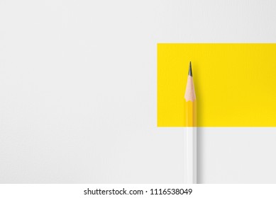 Minimalist Presentation Template With Copy Space By Close Up Photo Of Yellow Pencil Isolated On White Paper And Combine With Yellow Rectangle Shape. Flashlight Made Smooth Lighting On Yellow Pencil.