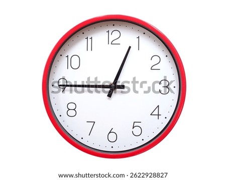 Minimalist red framed wall clock pointing at 00:45 or 12:45. Isolated on white background. Concept of time management.