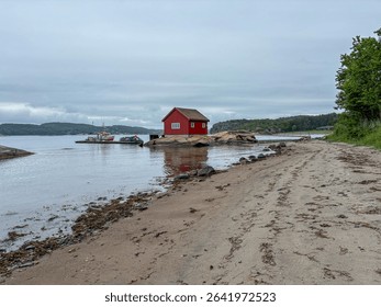 Minimalist Red House on Rocky Seashore – Engebukta, Norway