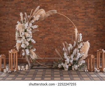 Minimalist round wedding arch, boho style wedding arch with leaves and pampas ros, decorated wedding arch in the mountain under the trees - Powered by Shutterstock