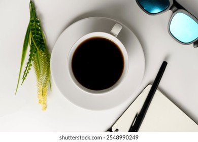 A minimalist setup featuring a cup of black coffee, sunglasses, notebook, and pen on a white background. Ideal for concepts of relaxation, planning, and creativity. - Powered by Shutterstock