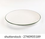 Minimalist studio shot of a single, empty white plate with a dark green rim. High-key lighting on a clean white background. Classic, simple design for food, dining, or conceptual use.