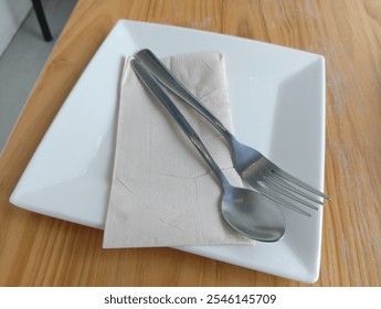 "Minimalist Table Setting with Fork and Spoon"

 - Powered by Shutterstock