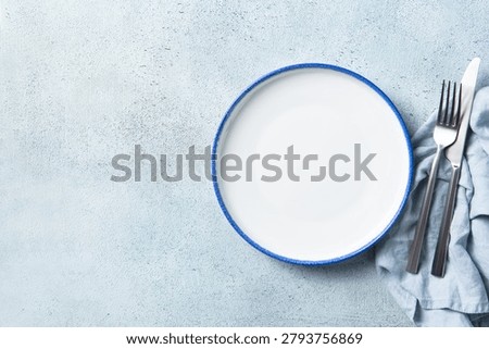 Minimalist table setting template with empty dish for restaurant food placement. Background for culinary card, recipe banner or menu layout. Copy space. Top view.