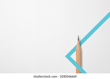 Minimalist template with copy space by top view close up photo of wooden pencil isolated on white paper and combination with blue green line shape graphic. Flash light made smooth shadow from pencil.