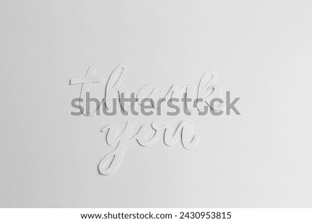 Minimalist thank you message crafted in stylish cursive font isolated on clean white backdrop.