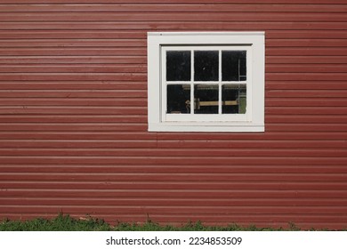 Minimalist view of a rectangular window on a typical bright red wall.