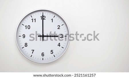 Minimalist White Clock with Silver Frame Striking 15.00 or 03.00 on White Background – Perfect for Time Management and Corporate Campaigns