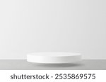 Minimalist white round platform on a gray surface. Simple, clean design. Perfect for showcasing products. White platform, gray surface. Minimal backdrop product platform with copy space.