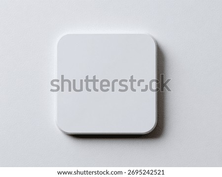 Minimalist white square button on a light background.