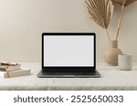 Minimalist workspace photo with laptop mock up on table, aesthetic beige decorative. Laptop with blank screen mock up on workspace with books and aesthetic decorative vases photo