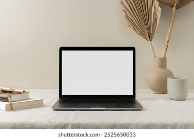 Minimalist workspace photo with laptop mock up on table, aesthetic beige decorative. Laptop with blank screen mock up on workspace with books and aesthetic decorative vases photo - Powered by Shutterstock