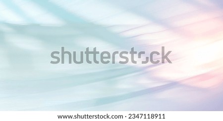 Minimalistic abstract blurred background of light blue and pink colors in pastel gentle shades. Shining light through a thin weave flying in the wind.