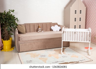 Minimalistic Baby's Room Interior With An Elegant Child's Bed And Sofa For Mom