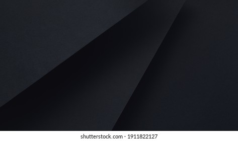 Minimalistic black dynamic background and diagonal lines  abstract dark geometric shape from paper and soft shadows background  top view  flat lay