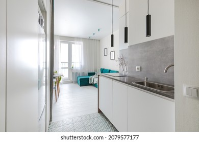 Minimalistic compact kitchen in a small apartment with elements of concrete, black and white - Shutterstock ID 2079577177