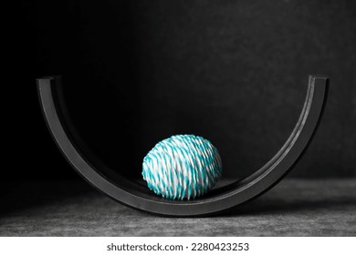 Minimalistic composition with colored egg and dark background