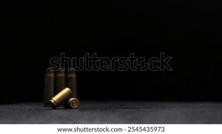 Minimalistic composition emphasizing military and dramatic elements with a focus on weaponry.