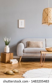 Minimalistic Design Home Interior Of Living Room With Gray Sofa, Wooden Coffee Table, Photo Frame, Flowers, Rattan Lamp, Basket And Elegant Accessories. Stylish Home Decor. Template. Gray Walls.