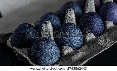 minimalistic easter eggs in blue tones. cosmic blue and purple dark painted eggs, space, stone, concrete effect. hibiscus, dye, rice, mother of pearl