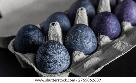 minimalistic easter eggs in blue tones. cosmic blue and purple dark painted eggs, space, stone, concrete effect. hibiscus, dye, rice, mother of pearl