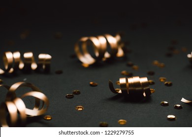 Minimalistic golden decor on black background. Selective focus. Festive concept. - Powered by Shutterstock