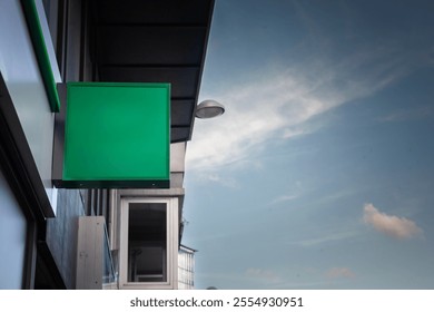 Minimalistic green signage hanging outside a Belgian storefront. A modern blank canvas for business advertisement or branding in a contemporary urban setting. - Powered by Shutterstock