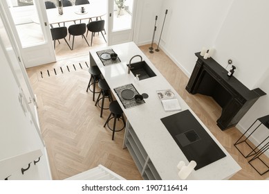 Minimalistic Kitchen With A Door Leading To The Outside Open-air Dining Space With Table And Chairs