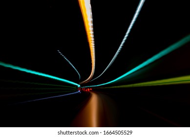 Minimalistic Light Trails In Green And Orange On Black Background