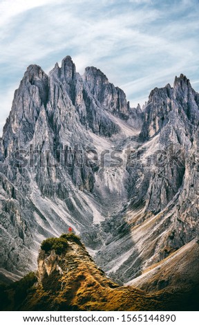 Minimalistic mountains landscape with man against huge peaks