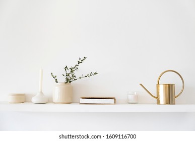 Minimalistic Scandinavian interior. Dishes on white shelves. White details in the interior.