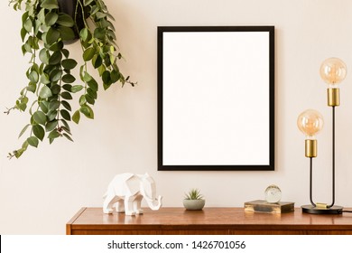 Minimalistic And Stylish Mock Up Poster Frame Concept With Retro Furnitures, Hanging Plant, Gold Table Lamp And Elegant Accessories. White Walls, Home Decor. Nice Interior Of Living Room. Real Photo.