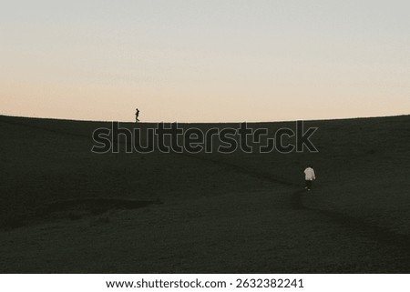 A minimalistic view of a dark empty road at dusk, with a calm sky above and faint horizon light, creating a moody and mysterious atmosphere.