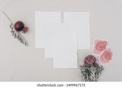 Minimalistic Wedding Composition With Cards Mock Up, Flowers, Pomegranate On White Background. Flat Lay, Top View Stylish Art Concept.