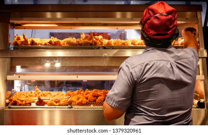 Minimum Wage Employee Works In A Fast Food Kitchen